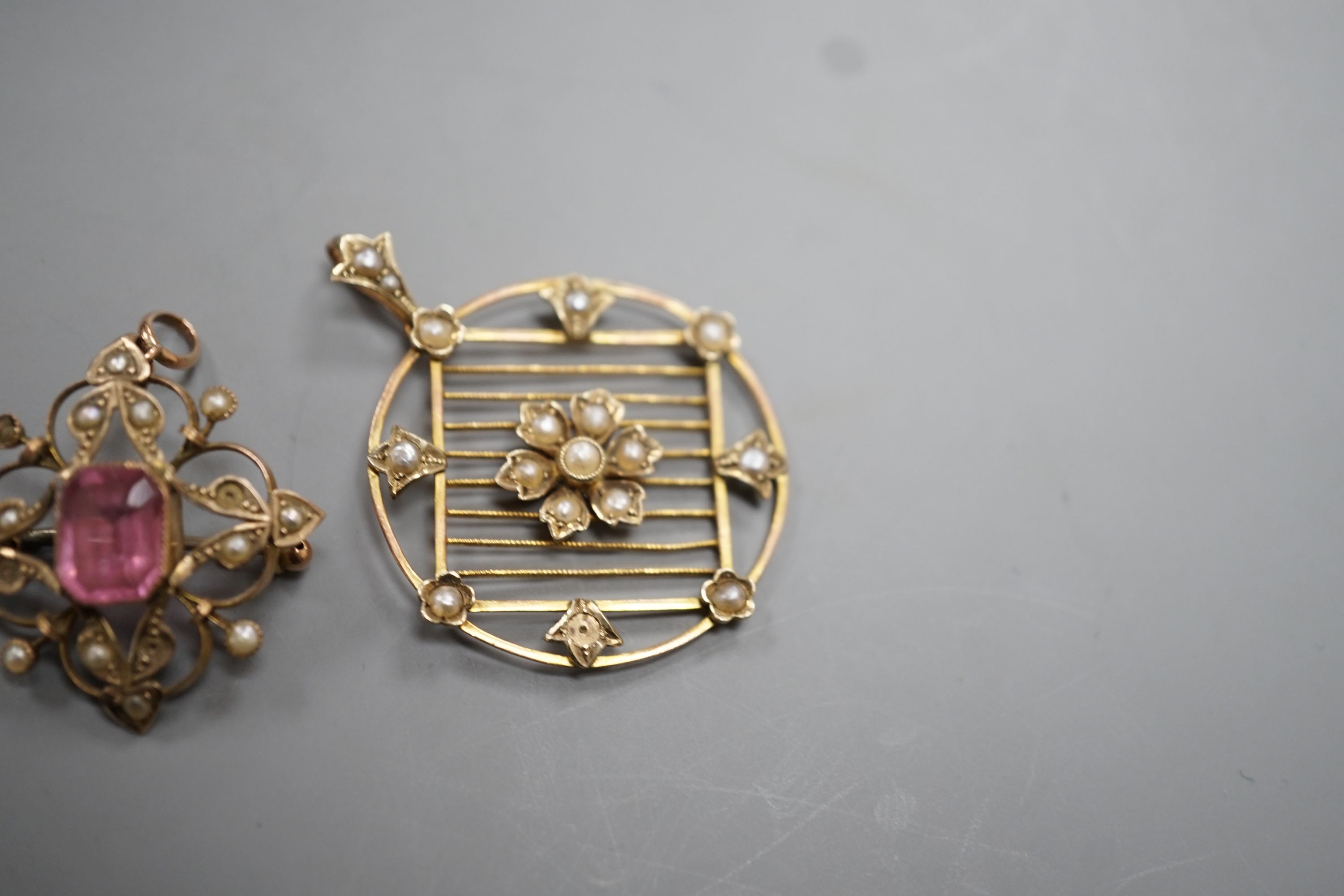 An Edwardian 9ct and seed pearl set circular pendant , 31mm and a similar pink paste and seed pearl set pendant brooch, gross 7.2 grams.